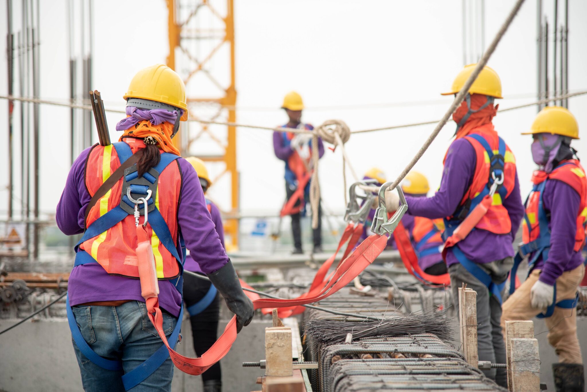 Workers on scaffolding with proper safety equipment
