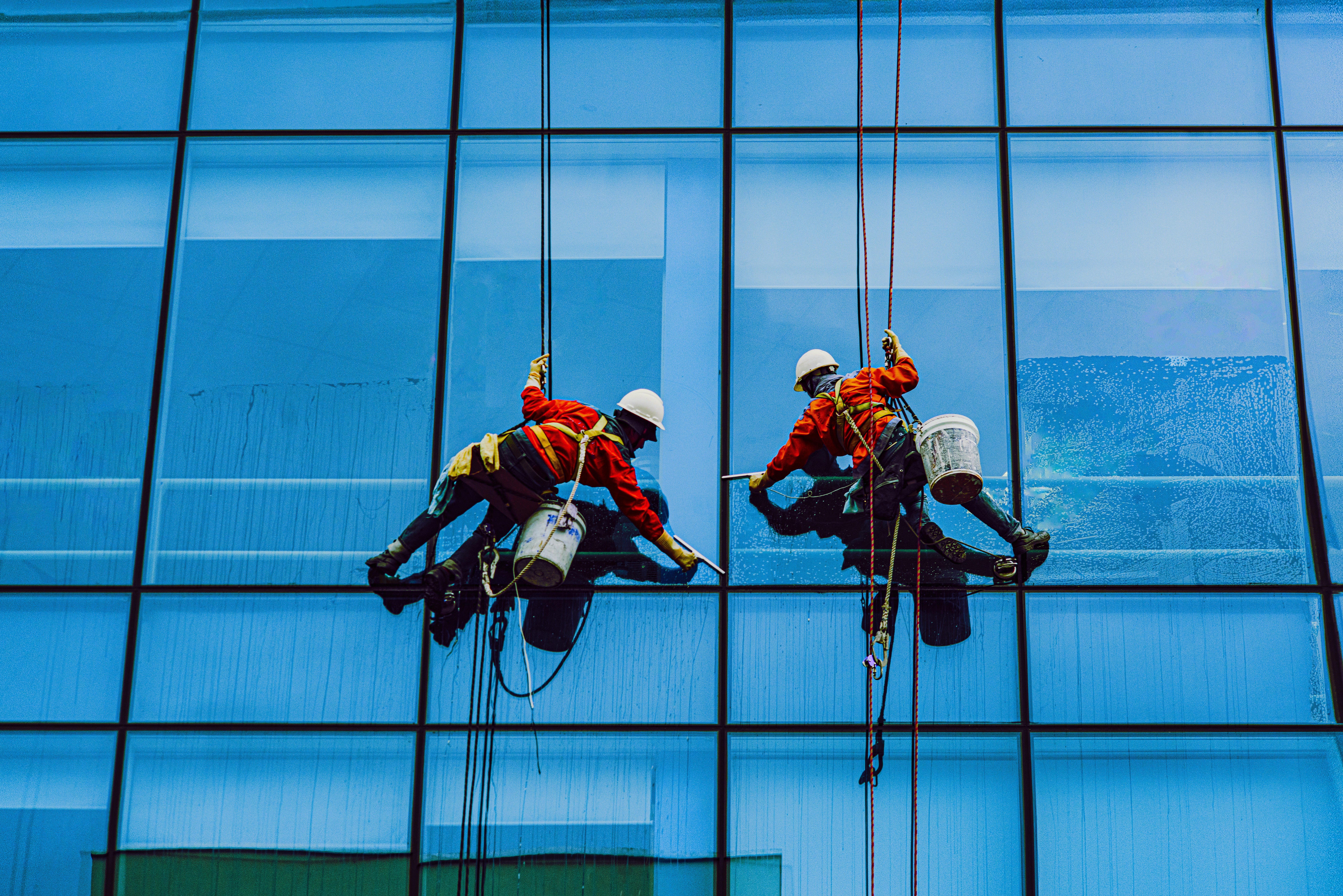 Workers cleaning the glass of building
